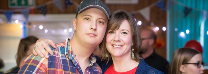 Harry Chadwick wearing a blue baseball cap and checked red shirt with his mum at his 18th birthday party